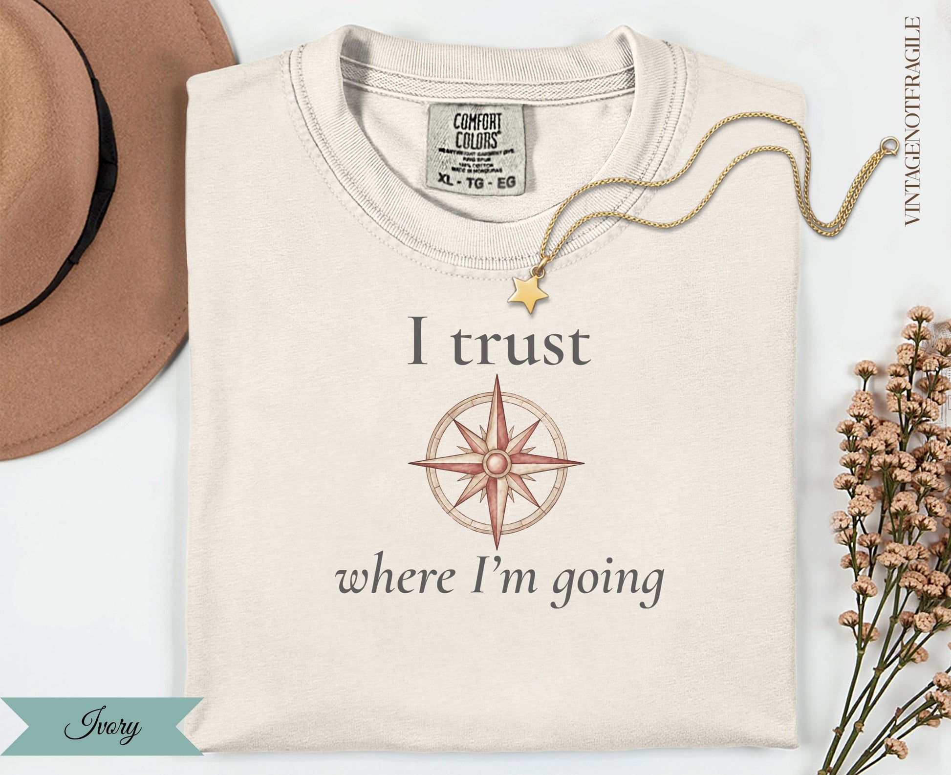 Cream t-shirt with compass and "I trust where I'm going" text.