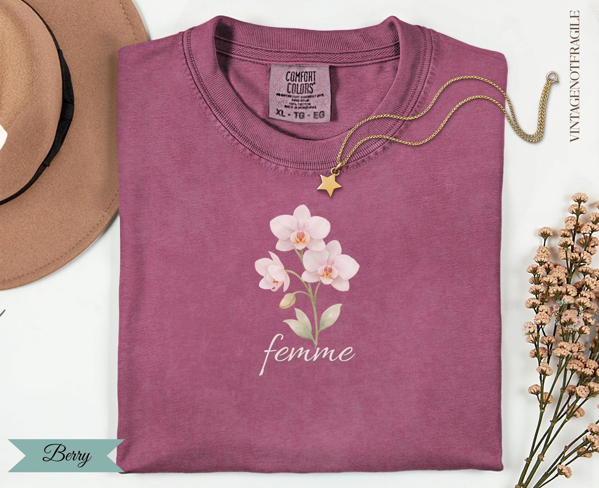 Berry colored Comfort Colors t-shirt with a floral and "femme" graphic.
