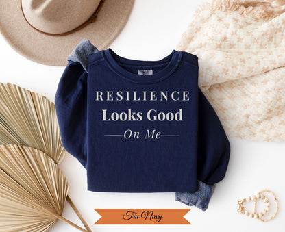 Navy crewneck sweatshirt with "Resilience Looks Good On Me" and "Tru Navy" text.