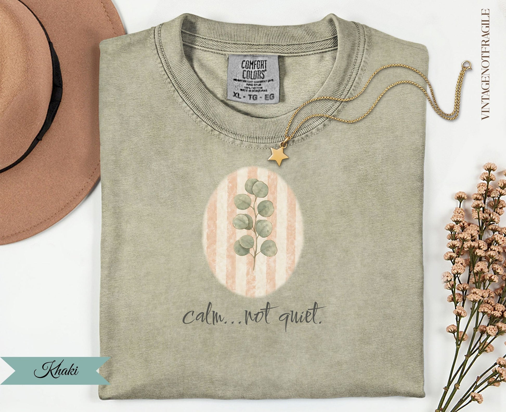 Khaki t-shirt with oval design and "calm...not quiet." text.