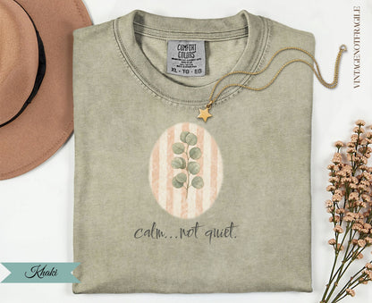 Khaki t-shirt with oval design and "calm...not quiet." text.