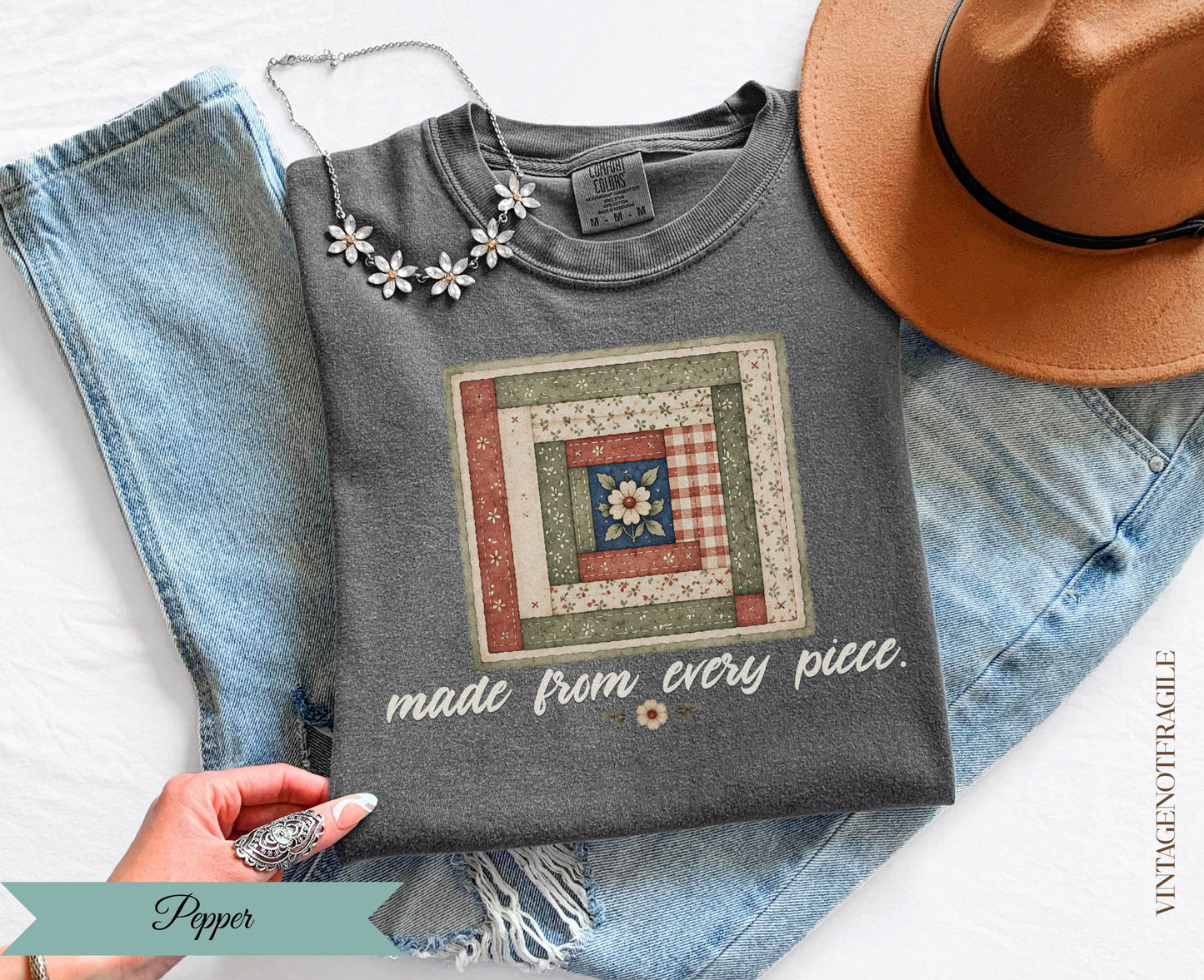 Dark gray t-shirt with a quilt graphic and "made from every piece." text.
