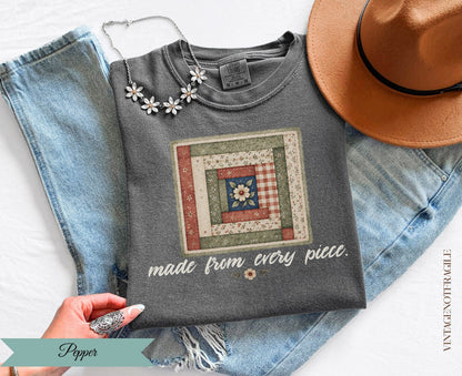 Dark gray t-shirt with a quilt graphic and "made from every piece." text.