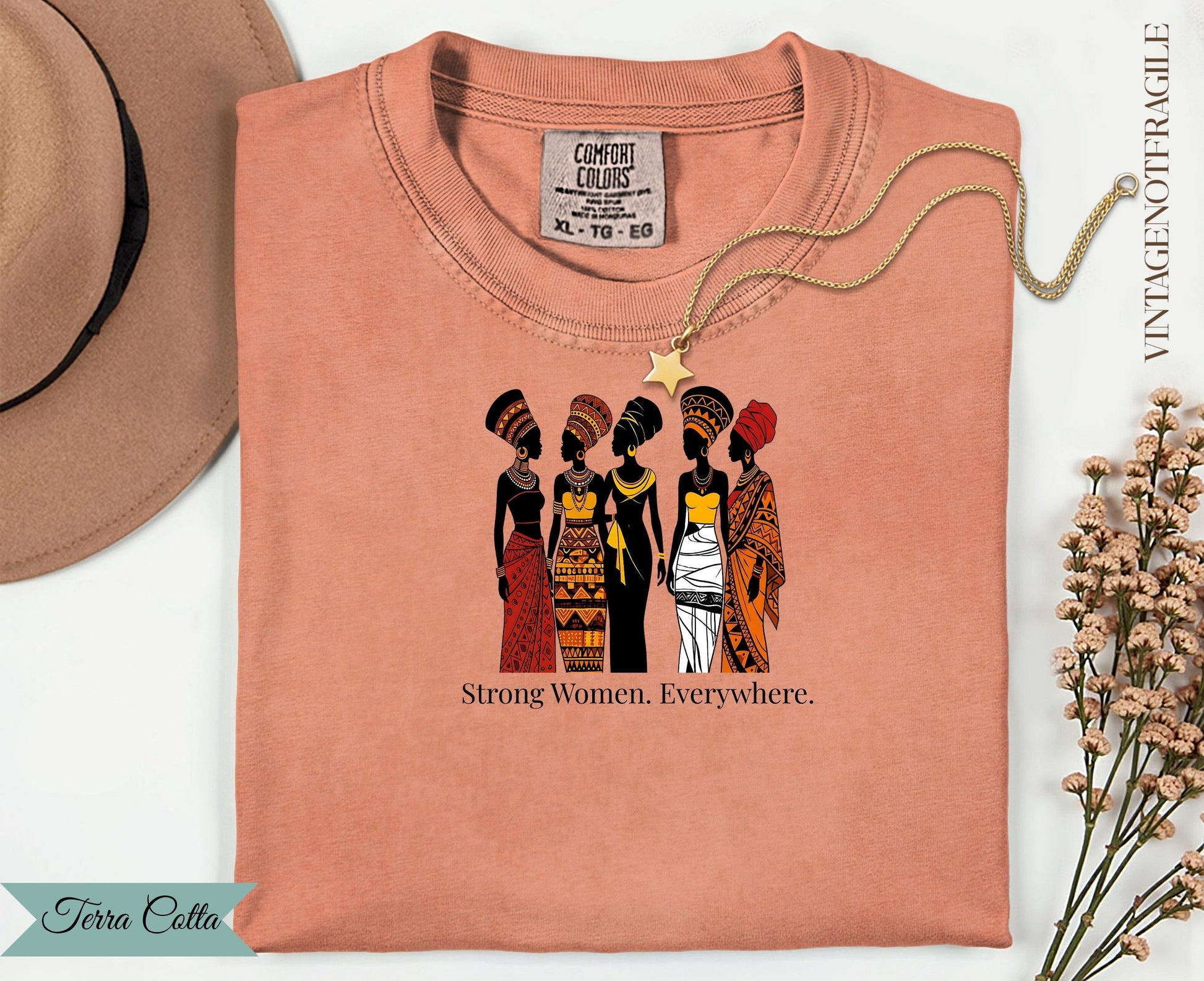 T-shirt with five women in patterned clothing and text "Strong Women. Everywhere."