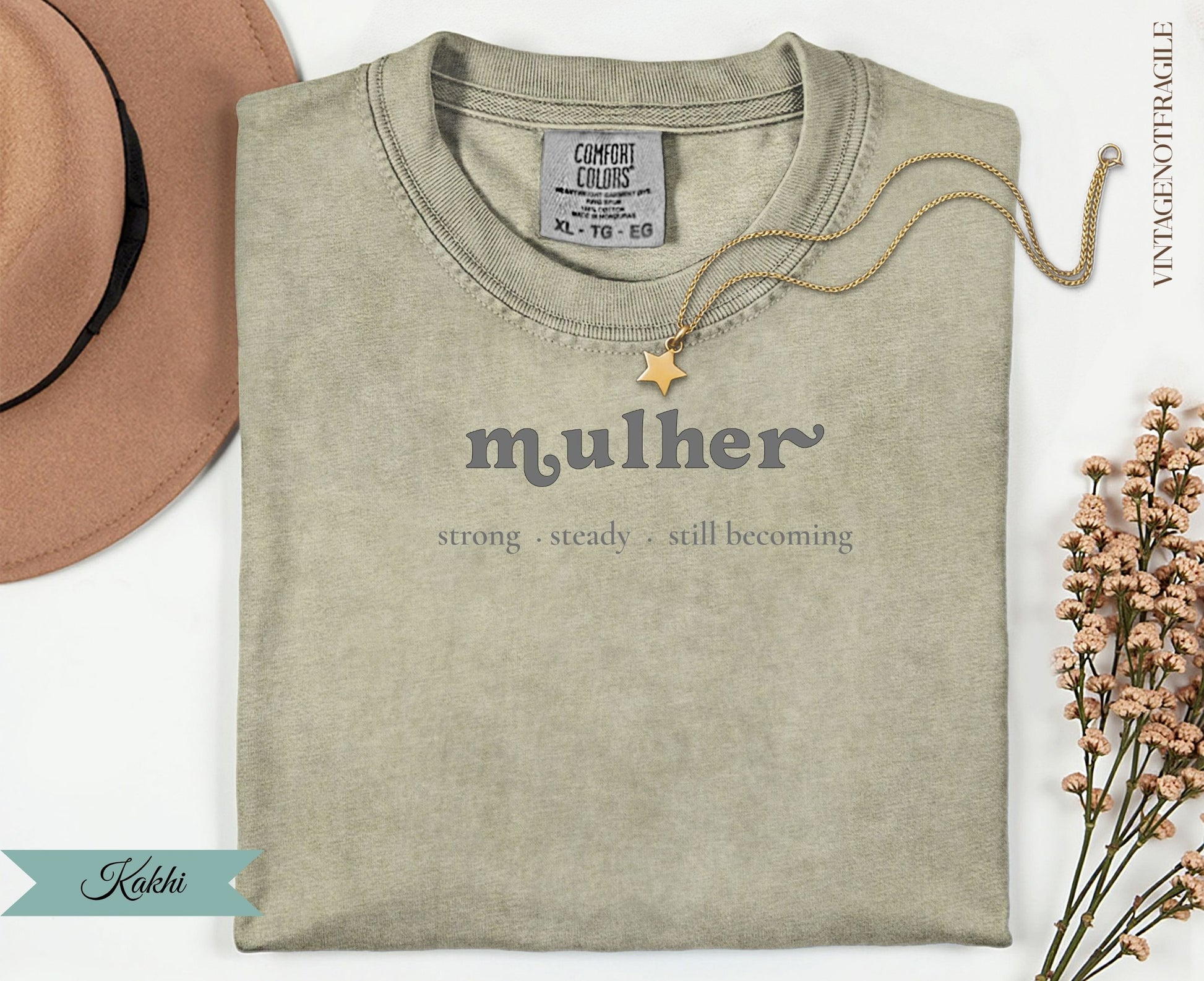 Kakhi Comfort Colors t-shirt with "mulher strong steady still becoming" text.
