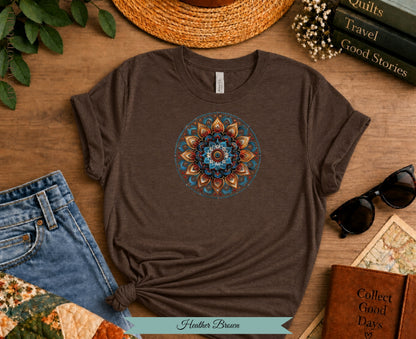 Brown t-shirt with colorful mandala print, jeans, sunglasses, and books.