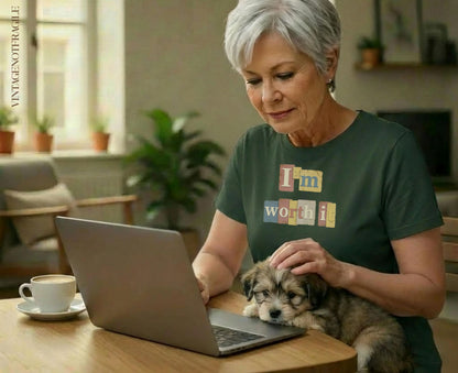 Woman petting puppy, laptop open, wearing "I'm Worth It" t-shirt.