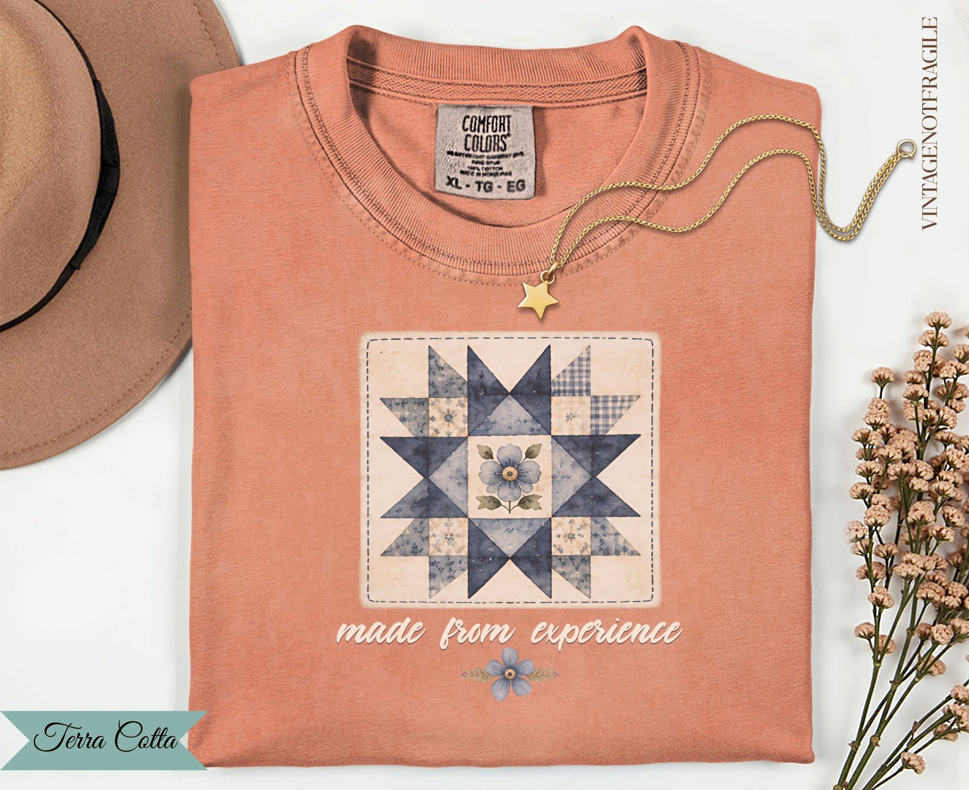 Coral t-shirt with a blue and white quilt square graphic and "made from experience" text.