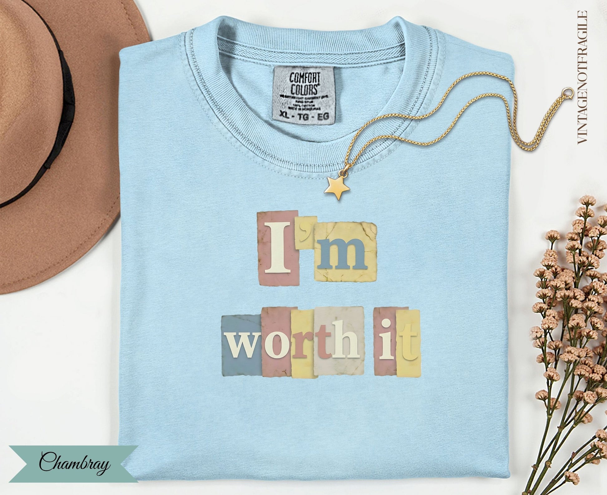 Light blue t-shirt with "I'm worth it" text and a small gold star charm.