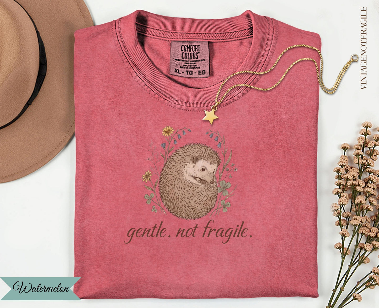 Pink t-shirt with hedgehog illustration and "gentle. not fragile." text.
