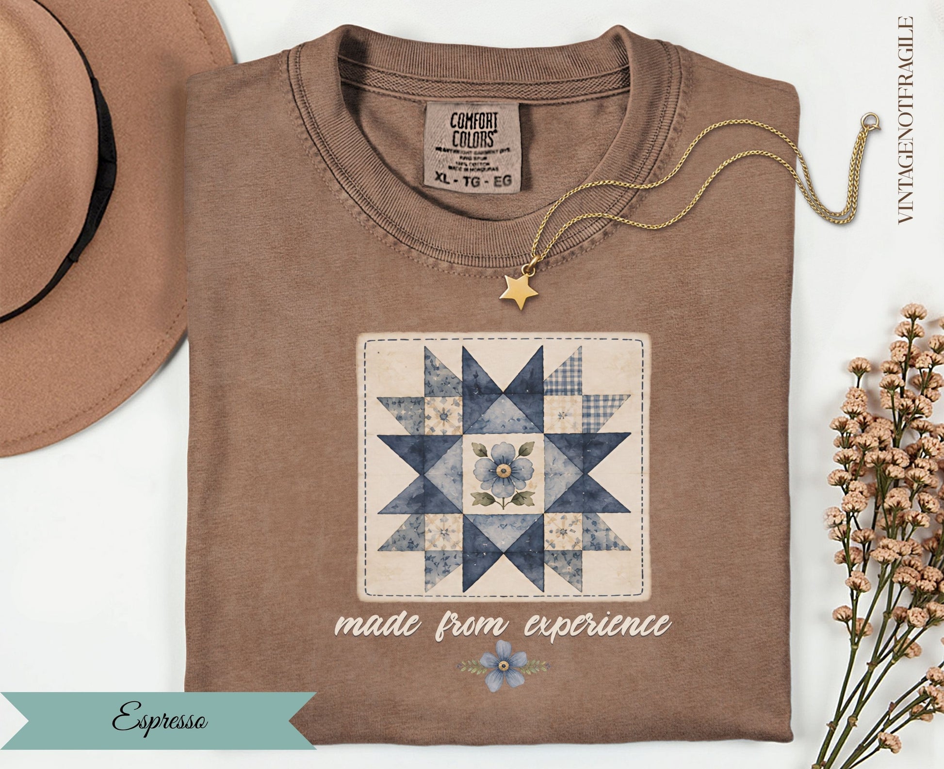 Brown t-shirt with a blue floral quilt design and "made from experience" text.