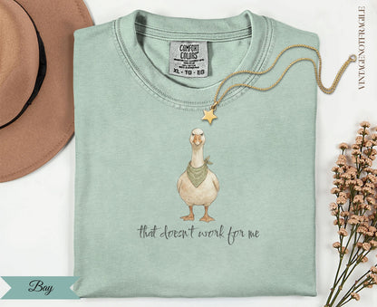 Light green t-shirt with a goose in a bandana saying "that doesn't work for me".